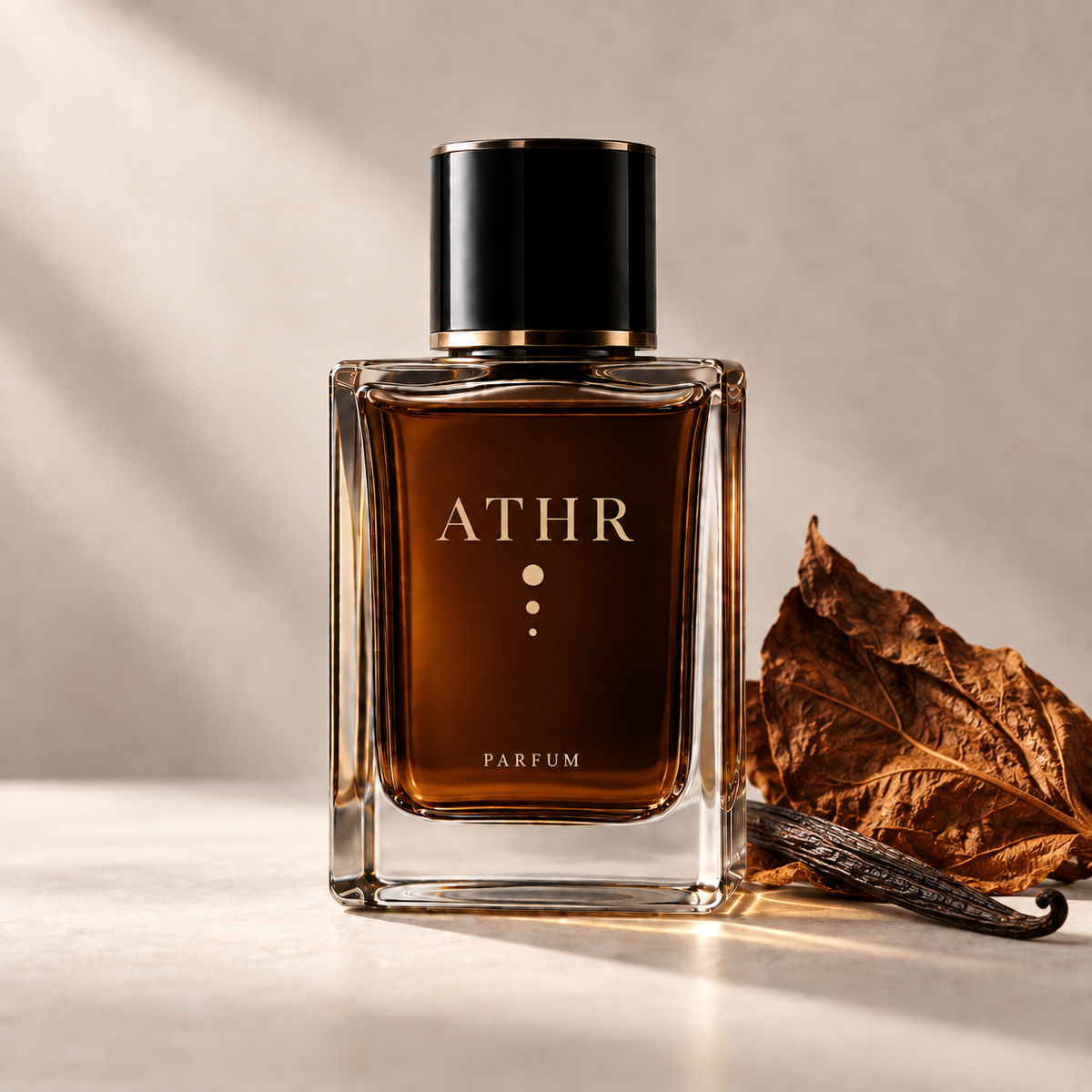ATHR Jamr eau de parfum bottle with a dried tobacco leaf and vanilla pod